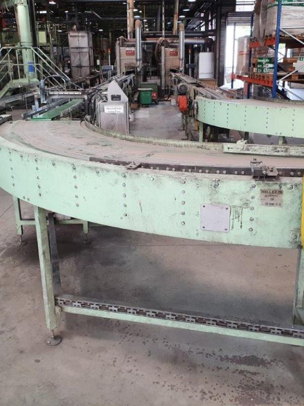 Curved conveyor in production line producing roof tiles.